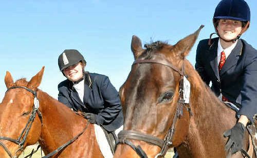Ellie Charlton and Rose Stacey thank their horses after a busy day of dressage. Ellie Charlton and Rose Stacey thank their horses after a busy day of dressage.